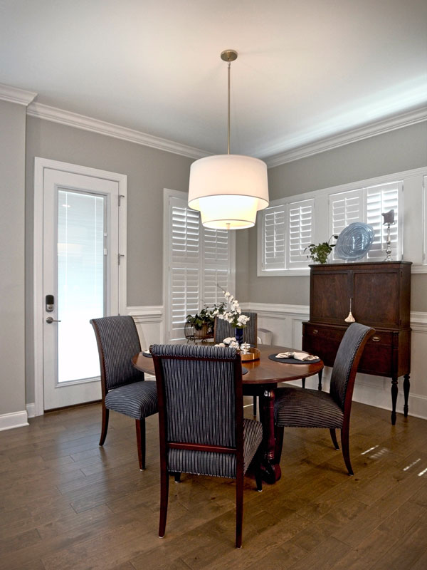 Open plan home with definition of the dining room using a large light fixture.