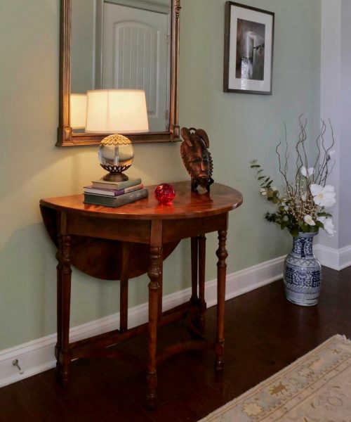 Small entryway showing console table and eclectic style interior design.